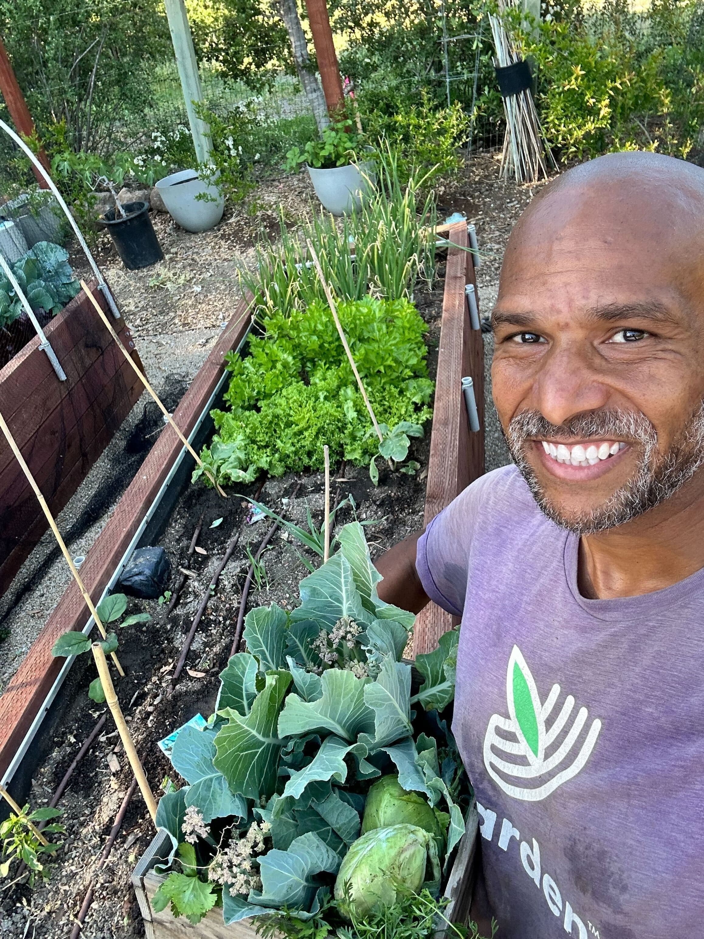 Gardener holding fresh harvest from a Yarden class in Alameda